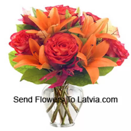 Orange Lilies And Orange Roses With Seasonal Fillers Arranged Beautifully In A Glass Vase