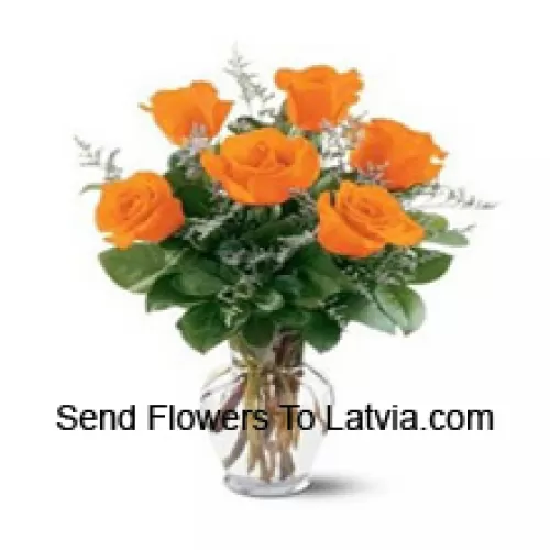 7 Yellow Roses With Some Ferns In A Glass Vase