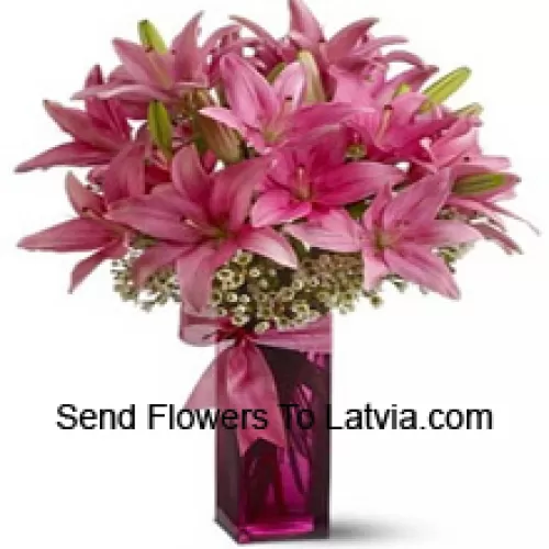Beautiful Pink Lilies With Some Ferns In A Glass Vase