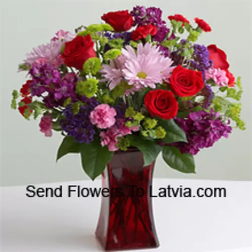 Red Roses, Pink Carnations And Other Assorted Seasonal Flowers In A Glass Vase
