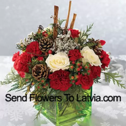 Send this bouquet of holiday colours - white roses, red carnations and Christmas greens - to express your happiest holiday wishes. Arranged in a glass cube with cinnamon sticks and pinecones, it's a wonderful gift for anyone on your list (Please Note That We Reserve The Right To Substitute Any Product With A Suitable Product Of Equal Value In Case Of Non-Availability Of A Certain Product)