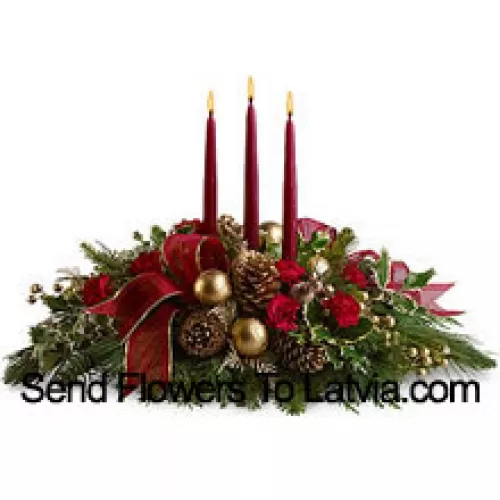 Red miniature carnations, pinecones, golden ornament balls, faux berries and assorted fresh evergreens  accented with a wired ribbon are arranged in a low dish with three red taper candles. (Please Note That We Reserve The Right To Substitute Any Product With A Suitable Product Of Equal Value In Case Of Non-Availability Of A Certain Product)